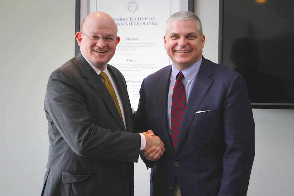 OTC Chancellor Hal Higdon and SBU President Eric Taylor finalize a transfer deal with a handshake.